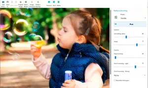 Program do wyostrzania zdjęć Easy Photo Unblur poprawia ostrość obrazu dziewczynki puszczającej bańki.